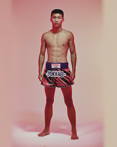 custom navy blue Muay Thai shorts with red trim by YOKKAO